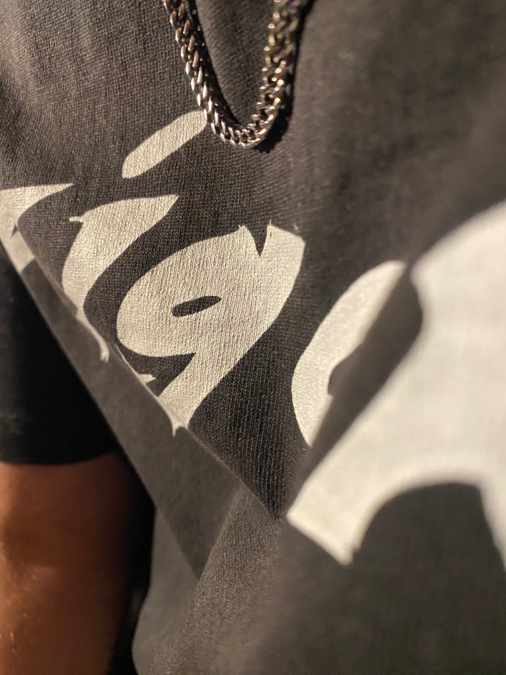 Close-up of a logo on a dark fabric surface